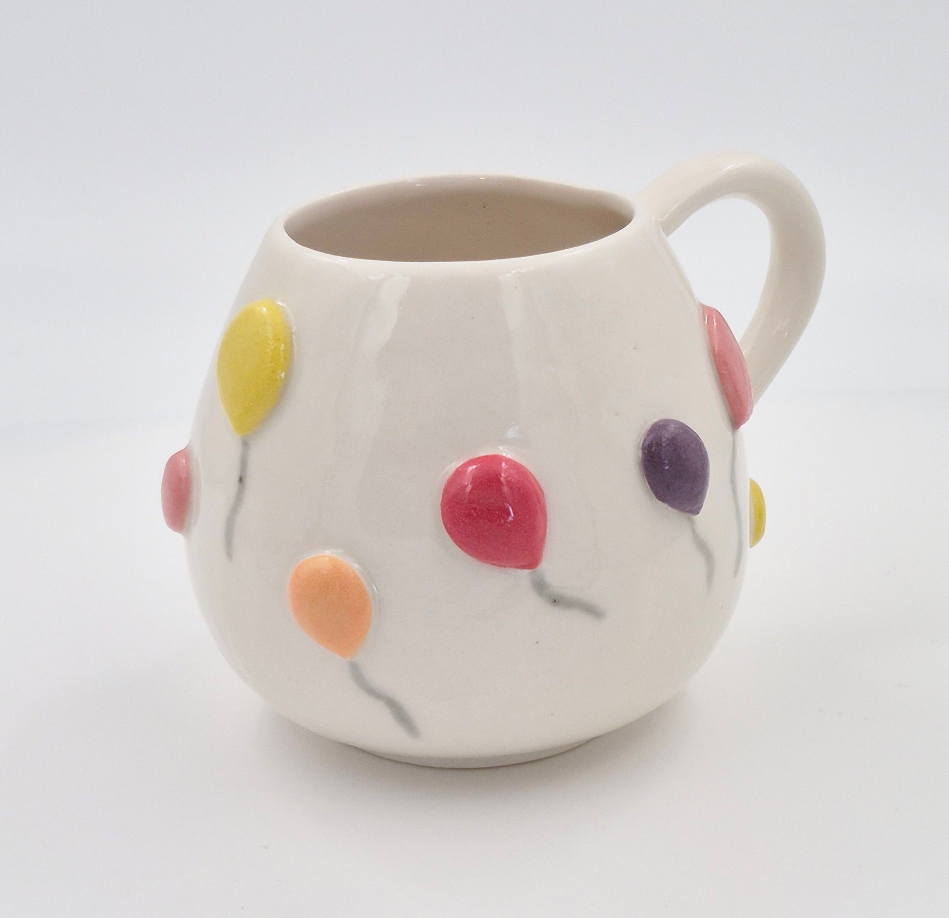 Farverigt krus med balloner